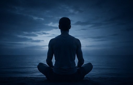 Dark blue silhouette in quiet meditation beside water