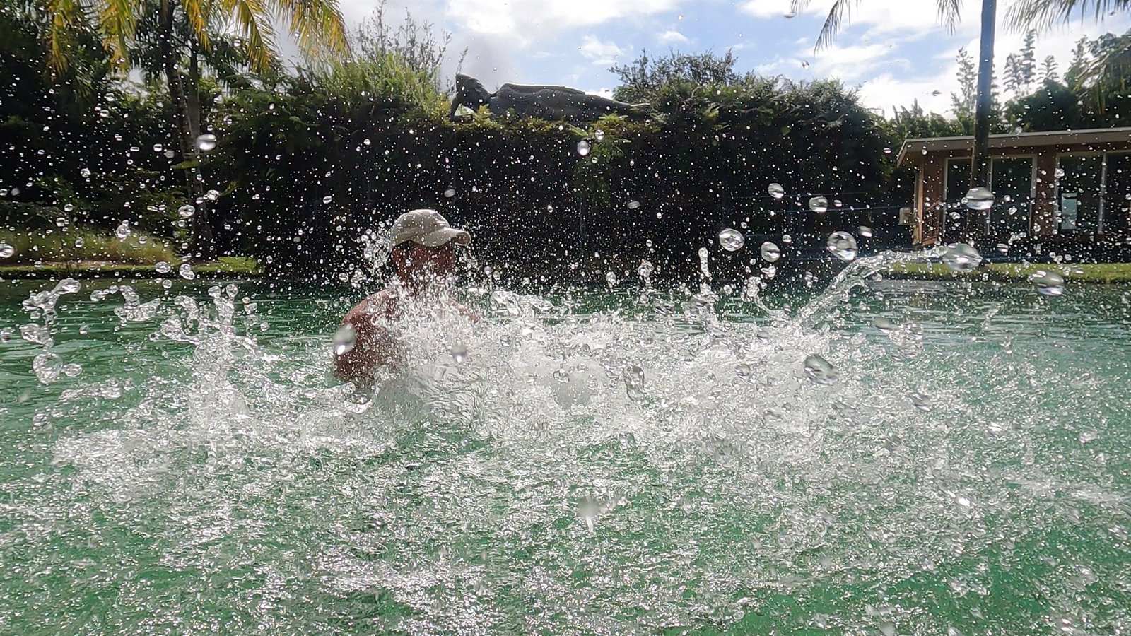 AquaFit Sports founder Stu Davidson driving through the water during oscillation training, white water erupting around him